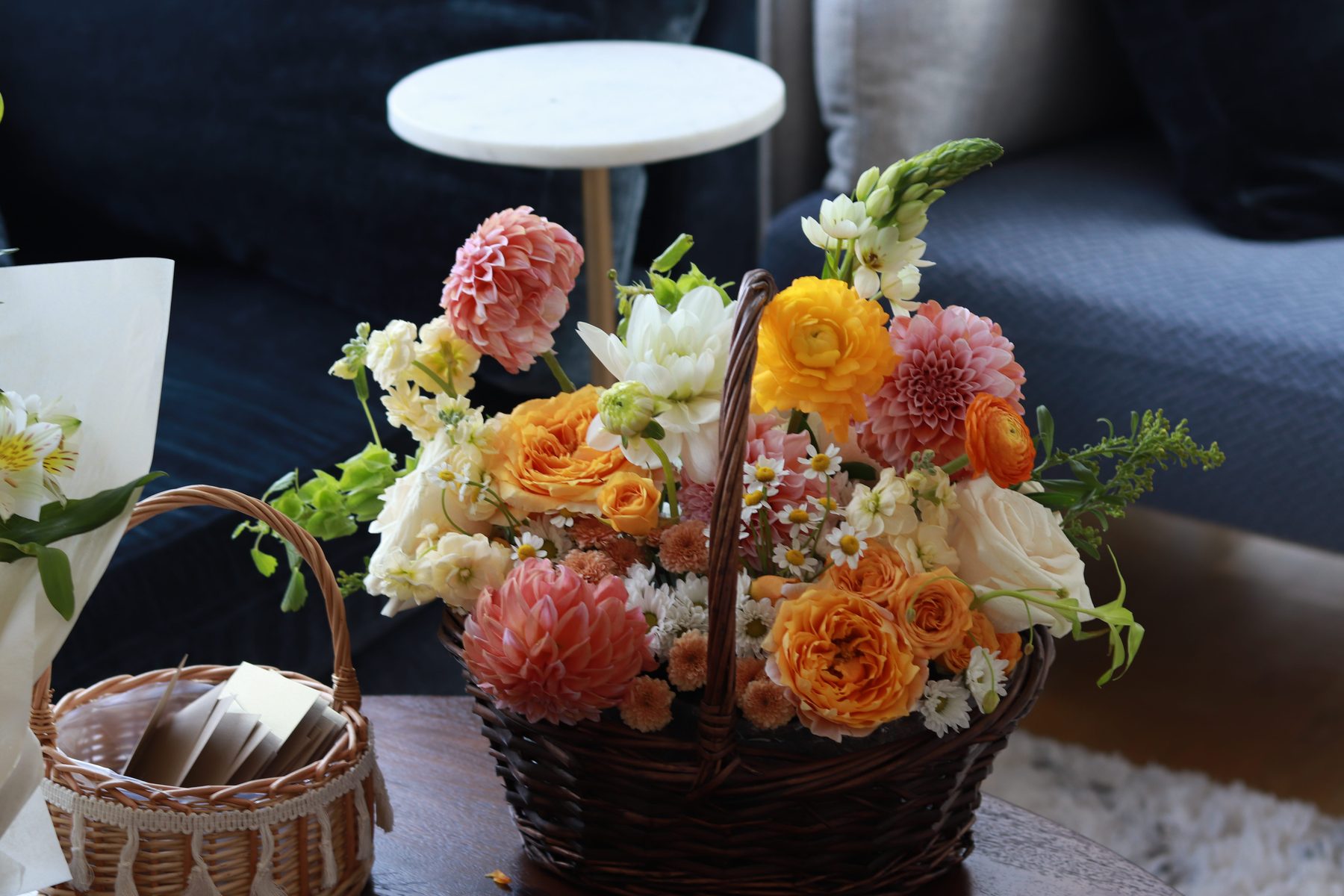 Dahlia, garden rose, and ranunculus gift basket arrangement