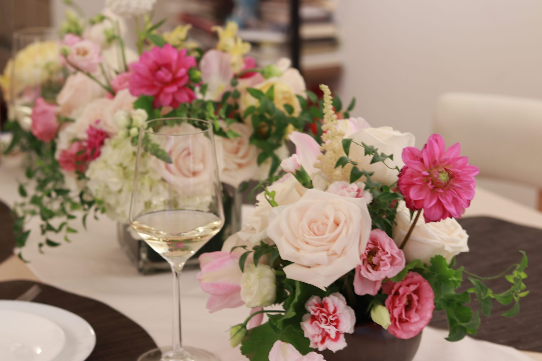 Row of low centerpieces styled along a reception table